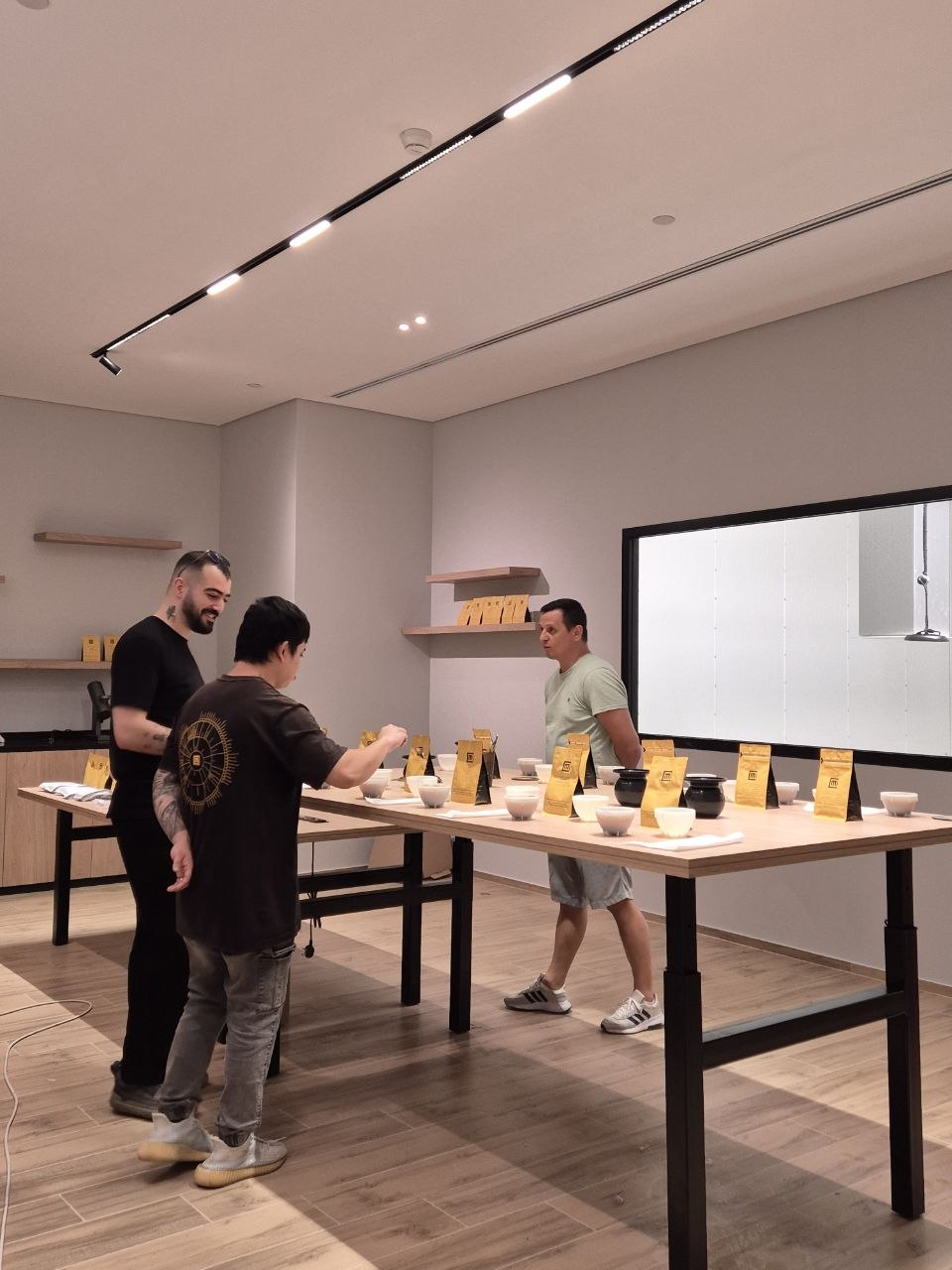 A coffee cupping session around a long table